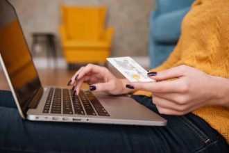 Femme utilisant son ordinateur pour effectuer un achat en ligne