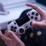 person holding white and black game controller